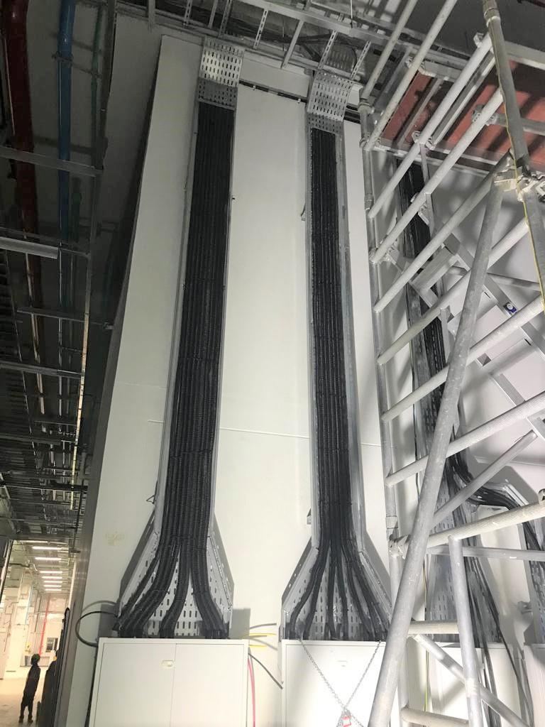 Electrical cabling installed through vertical cable trays