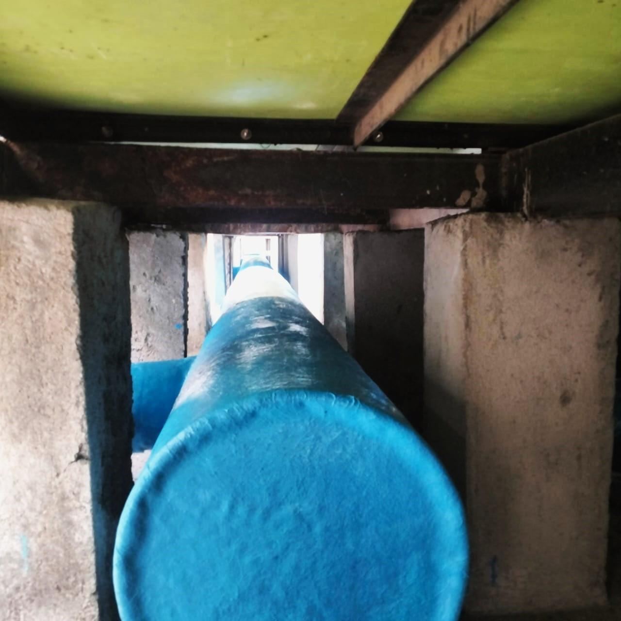 Close-up of FRP coated pipe running through a service tunnel